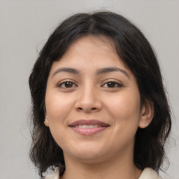 Joyful latino young-adult female with medium  brown hair and brown eyes