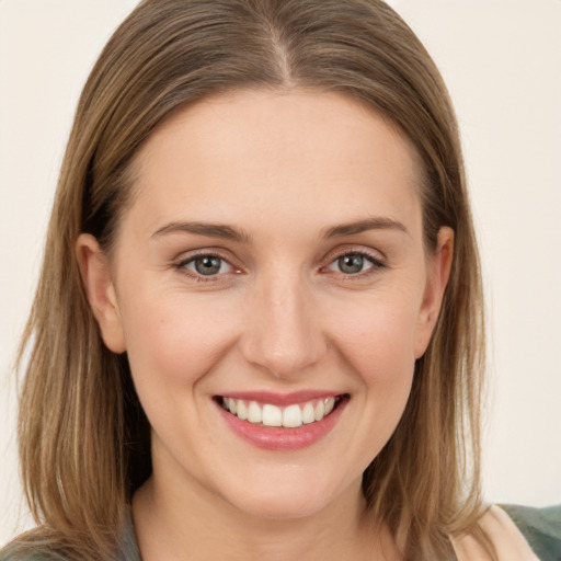 Joyful white young-adult female with medium  brown hair and grey eyes