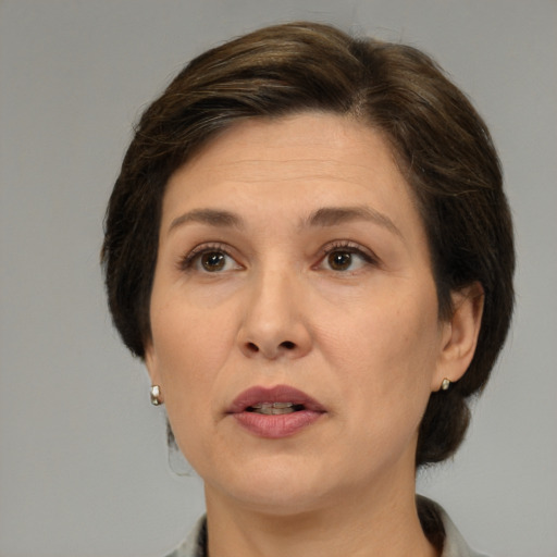 Joyful white adult female with medium  brown hair and brown eyes