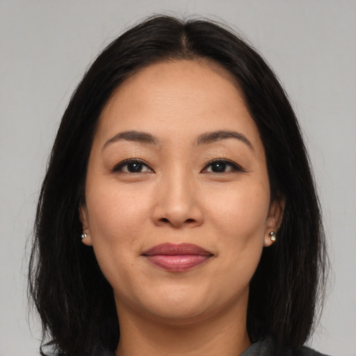 Joyful asian young-adult female with medium  brown hair and brown eyes