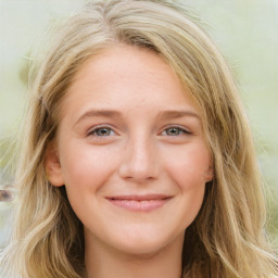 Joyful white young-adult female with long  brown hair and blue eyes