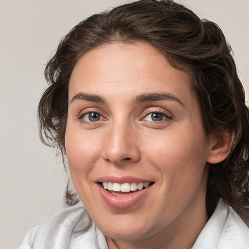 Joyful white young-adult female with medium  brown hair and blue eyes