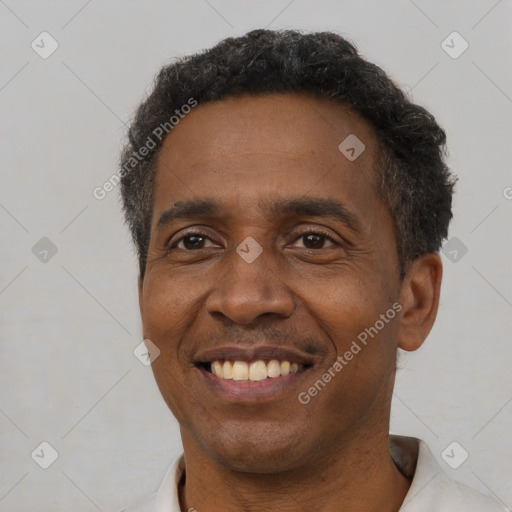 Joyful latino adult male with short  black hair and brown eyes