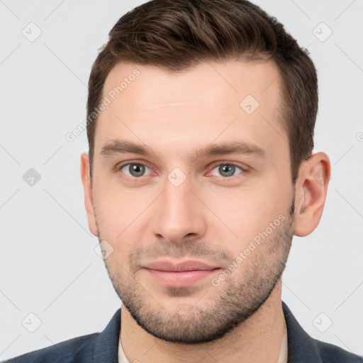 Joyful white young-adult male with short  brown hair and brown eyes