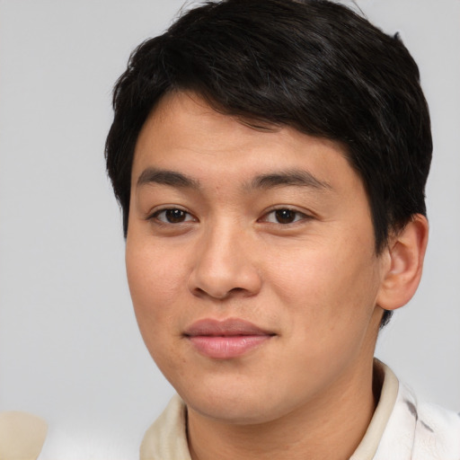Joyful asian young-adult male with short  brown hair and brown eyes