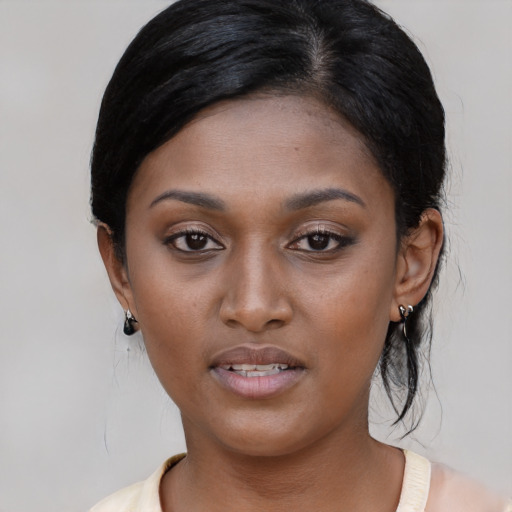 Joyful black young-adult female with medium  black hair and brown eyes