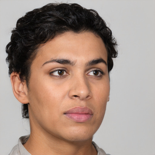 Joyful latino young-adult female with short  black hair and brown eyes