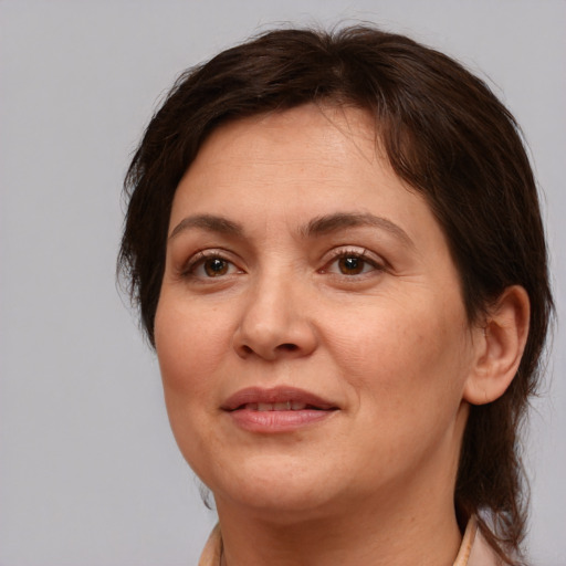 Joyful white adult female with medium  brown hair and brown eyes