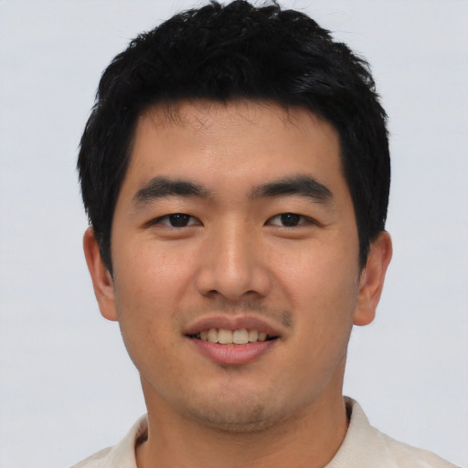 Joyful asian young-adult male with short  black hair and brown eyes