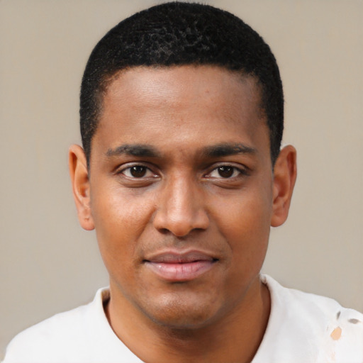 Joyful black young-adult male with short  black hair and brown eyes