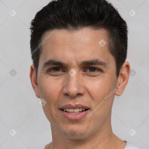 Joyful white young-adult male with short  black hair and brown eyes