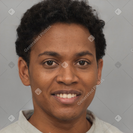 Joyful black young-adult male with short  brown hair and brown eyes