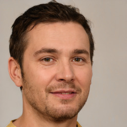 Joyful white young-adult male with short  brown hair and brown eyes