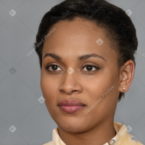 Joyful black young-adult female with short  brown hair and brown eyes