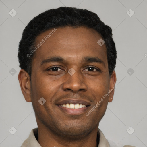 Joyful black young-adult male with short  black hair and brown eyes