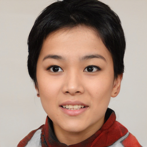 Joyful asian young-adult female with medium  black hair and brown eyes