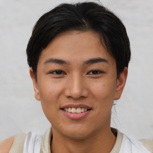 Joyful asian young-adult female with short  brown hair and brown eyes