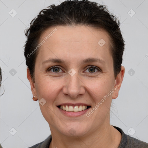 Joyful white adult female with short  brown hair and grey eyes