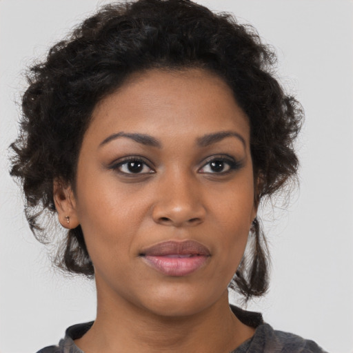 Joyful black young-adult female with medium  brown hair and brown eyes