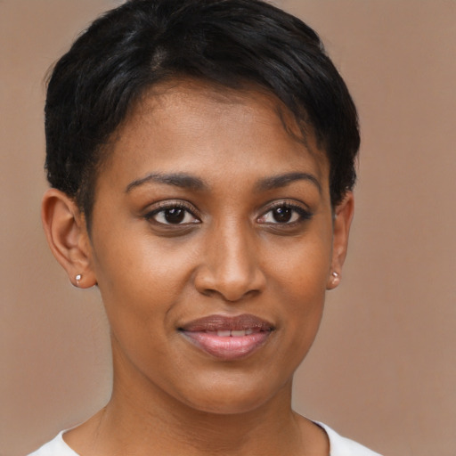 Joyful black young-adult female with short  brown hair and brown eyes