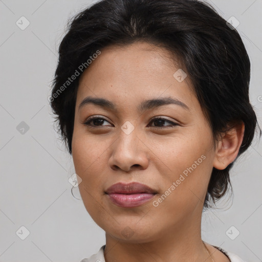 Joyful latino young-adult female with medium  brown hair and brown eyes