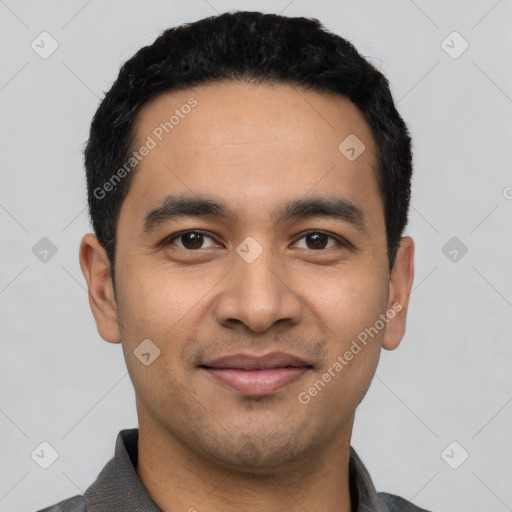 Joyful latino young-adult male with short  black hair and brown eyes