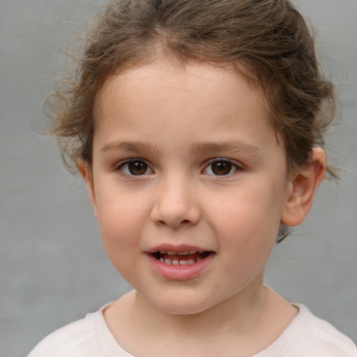 Joyful white child female with short  brown hair and brown eyes