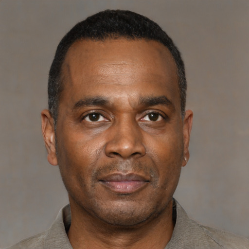 Neutral black adult male with short  black hair and brown eyes