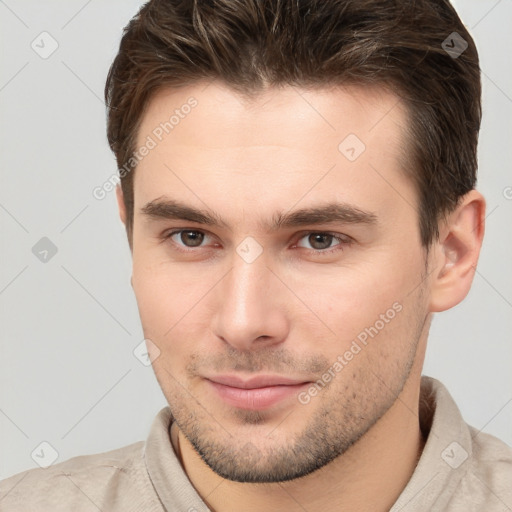 Joyful white young-adult male with short  brown hair and brown eyes