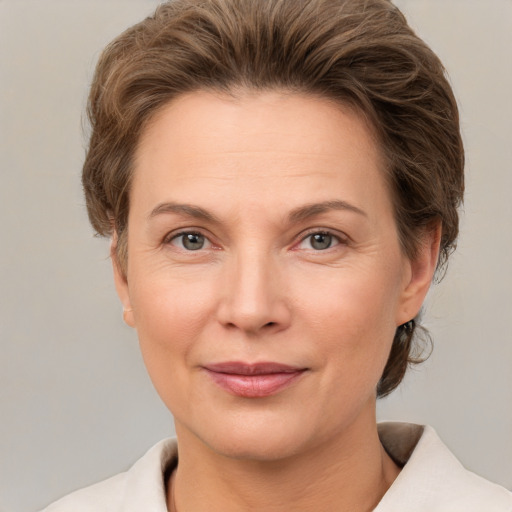 Joyful white adult female with short  brown hair and grey eyes