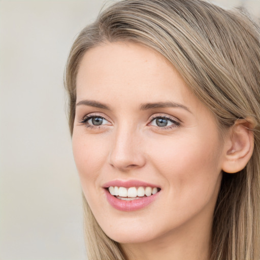 Joyful white young-adult female with long  brown hair and grey eyes