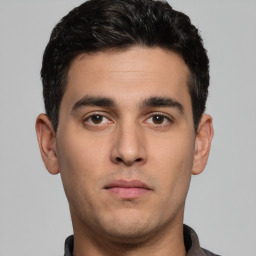 Neutral white young-adult male with short  black hair and brown eyes
