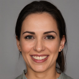 Joyful white young-adult female with medium  brown hair and brown eyes