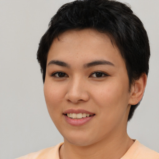 Joyful asian young-adult female with short  brown hair and brown eyes