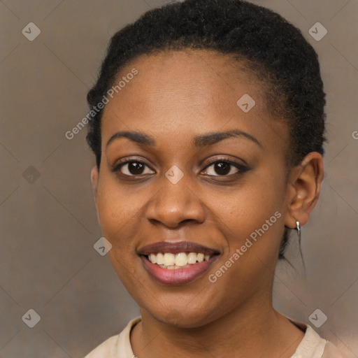 Joyful black young-adult female with short  brown hair and brown eyes