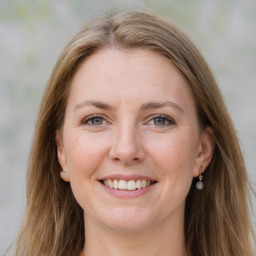 Joyful white young-adult female with long  brown hair and grey eyes