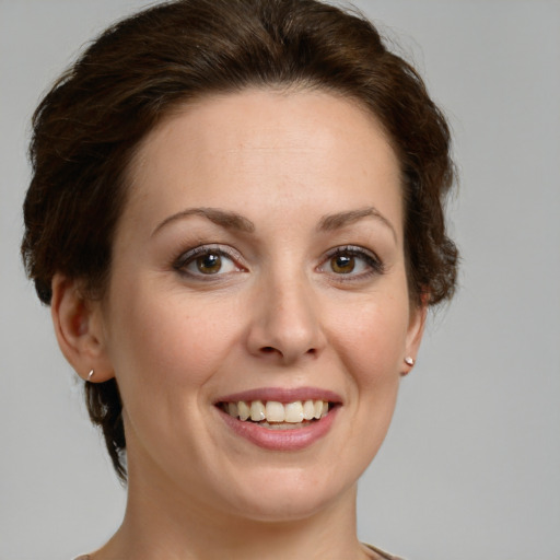 Joyful white young-adult female with medium  brown hair and green eyes