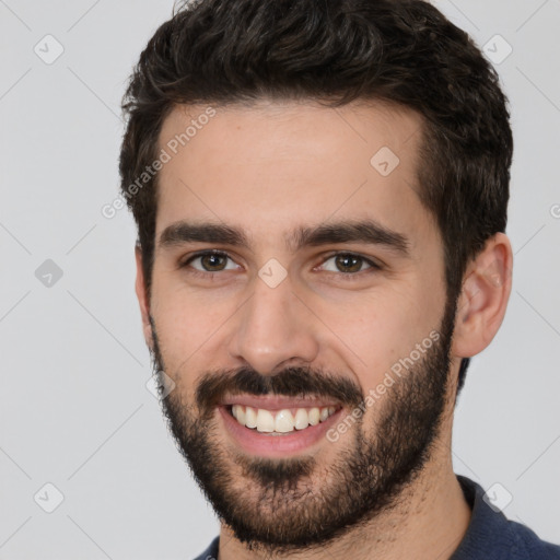 Joyful white young-adult male with short  black hair and brown eyes