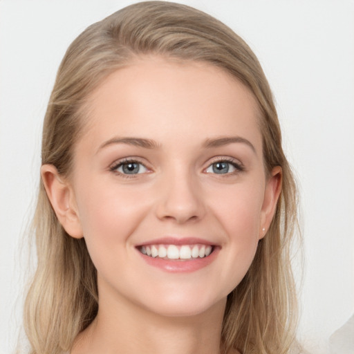 Joyful white young-adult female with long  brown hair and blue eyes