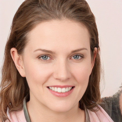 Joyful white young-adult female with long  brown hair and grey eyes