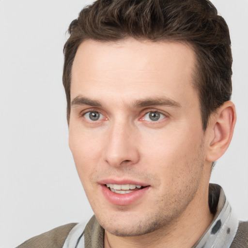 Joyful white young-adult male with short  brown hair and brown eyes