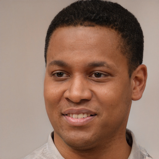 Joyful latino young-adult male with short  brown hair and brown eyes