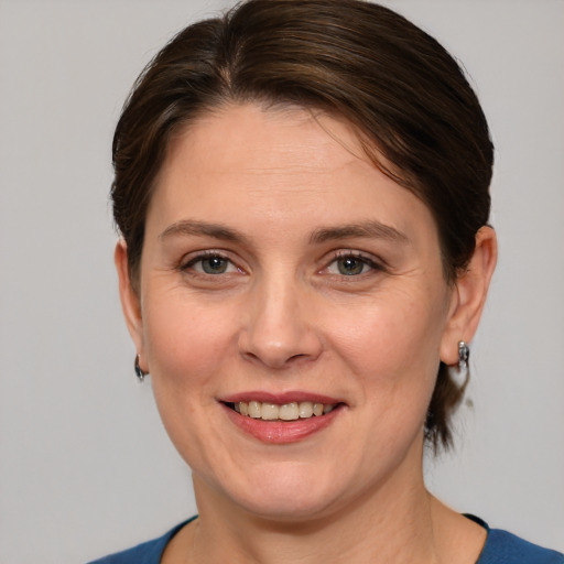 Joyful white adult female with medium  brown hair and brown eyes