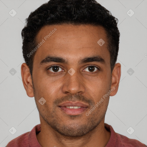 Joyful black young-adult male with short  brown hair and brown eyes