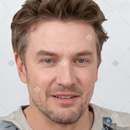 Joyful white adult male with short  brown hair and grey eyes