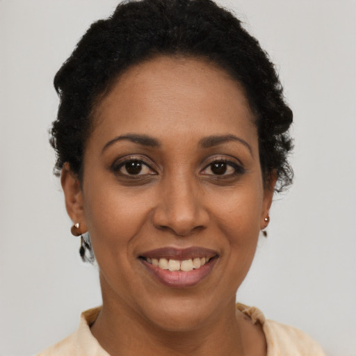 Joyful latino young-adult female with short  brown hair and brown eyes
