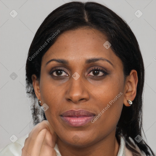 Joyful latino adult female with medium  black hair and brown eyes