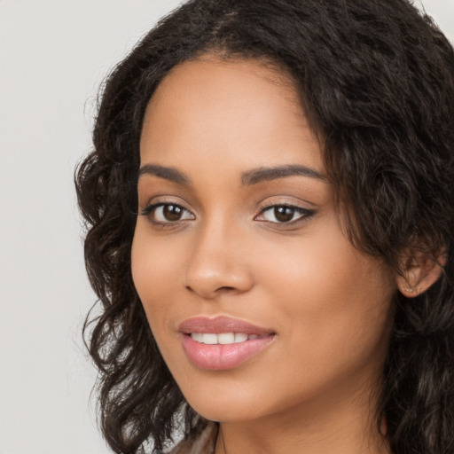 Joyful latino young-adult female with long  brown hair and brown eyes