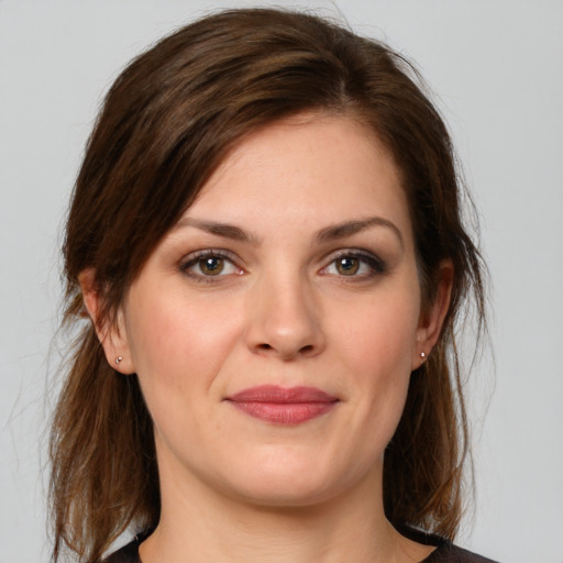 Joyful white young-adult female with medium  brown hair and brown eyes