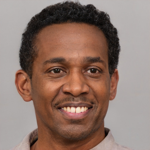 Joyful latino adult male with short  brown hair and brown eyes